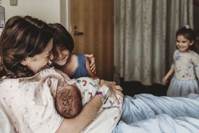 Mother and daughter on bed