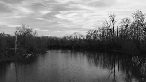 Scenic view of lake against cloudy sky