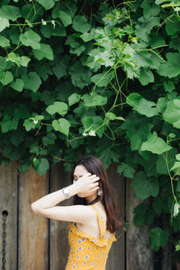 Woman standing by plants