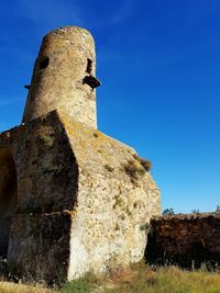 Low angle view of historical building against blue sky