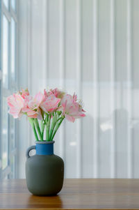 Close-up of pink flower vase on table