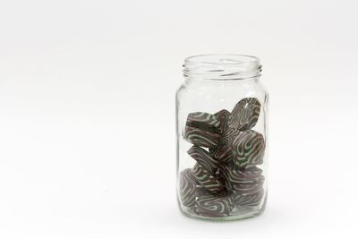 Close-up of jar over white background