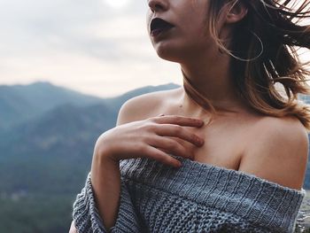 Midsection of woman against mountains