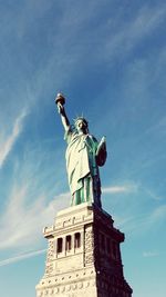 Low angle view of statue against cloudy sky