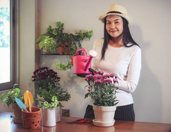 Portrait of smiling young woman in potted plant