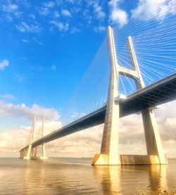 Low angle view of bridge over sea against sky