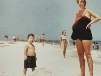 Friends standing on beach