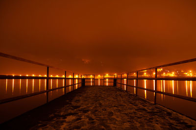 Bridge over lake during fog