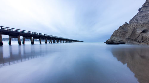 Bridge over sea against sky