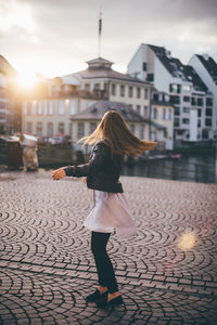 Young woman standing on street in city