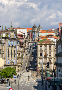 View of city street and buildings against sky