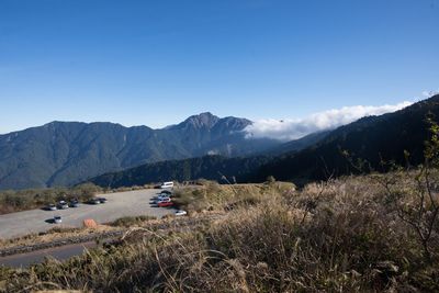 Scenic view of land and mountains against sky