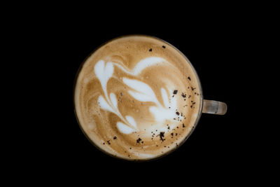 Close-up of coffee cup against black background