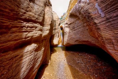 Low angle view of people walking on rocks