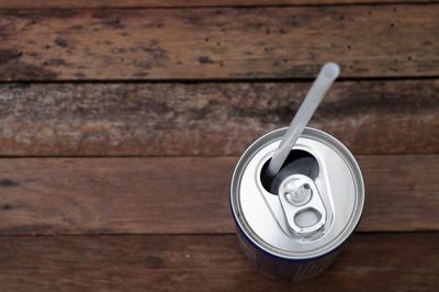 High angle view of drink can on wooden table