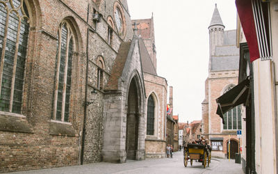 Man on street amidst buildings in city