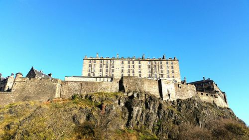 Low angle view of historical building against blue sky