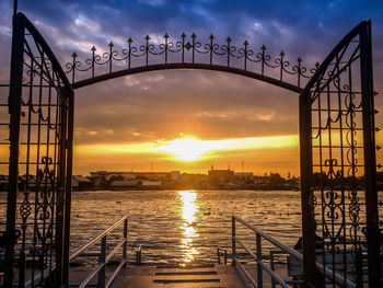 Silhouette bridge against sky during sunset