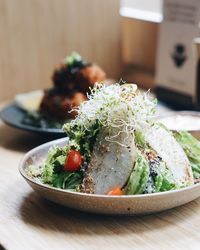 Close-up of healthy salad served in plate at table