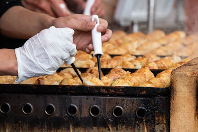 Midsection of man preparing food