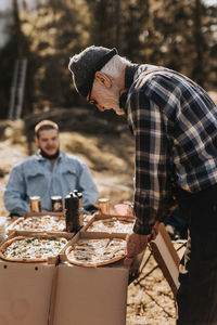 Senior man having pizza outdoors