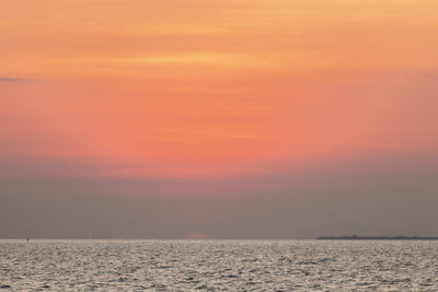Scenic view of sea against romantic sky at sunset