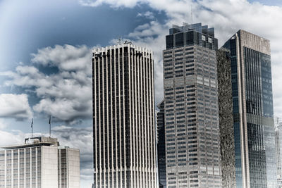 Low angle view of modern buildings against sky in city