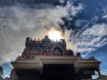 Low angle view of building against cloudy sky