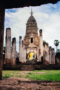 Old temple building against cloudy sky