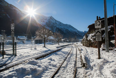 Sun shining over snow covered mountain