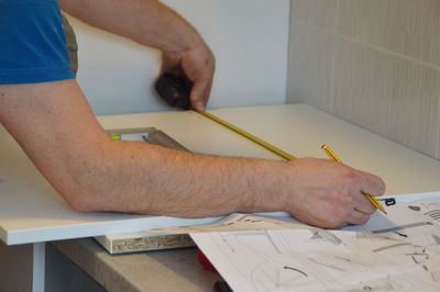 Close-up of craftsperson working on table