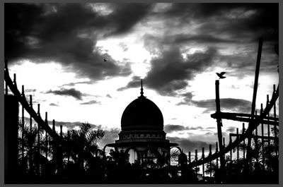 Low angle view of built structure against cloudy sky