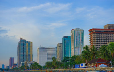 Buildings in city against blue sky