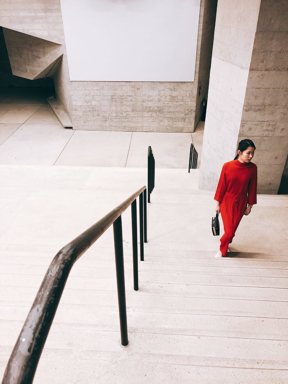 FULL LENGTH REAR VIEW OF MAN WALKING ON STAIRCASE OF BUILDING