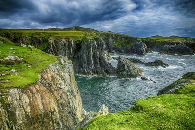 Scenic view of waterfall against sky