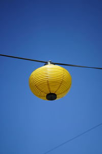 Low angle view of street light against clear blue sky