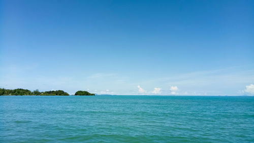 Scenic view of sea against blue sky