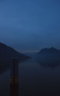 Scenic view of lake against sky at dusk