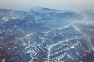 Aerial view of mountain range against sky