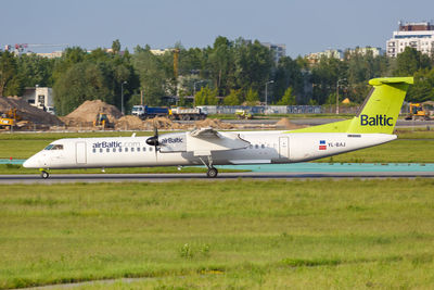 Airplane on field against sky