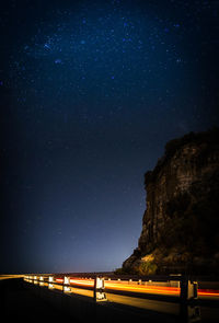 Low angle view of illuminated mountain against sky at night