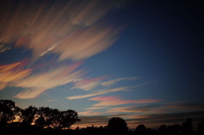 Low angle view of silhouette trees against sky at sunset