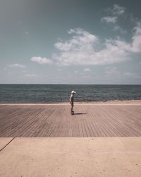 Full length of man on beach against sky