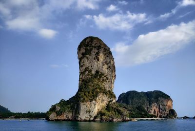 Rock formation in sea against sky