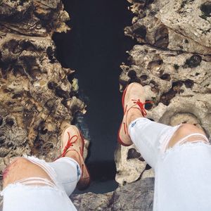 Low section of man standing on rocks