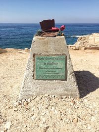 Rear view of text on beach against clear sky