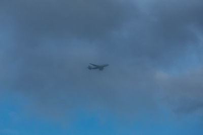 Low angle view of airplane flying in sky