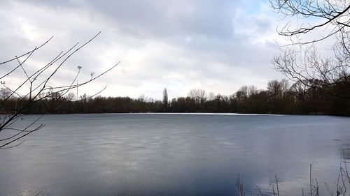 Scenic view of frozen lake against sky during winter