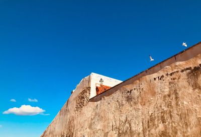 Low angle view of building against blue sky