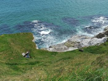 High angle view of rocks on sea shore